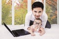 Dad with cute baby and laptop on bed Royalty Free Stock Photo