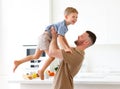 Dad and cute little son playing together and having fun at home Royalty Free Stock Photo