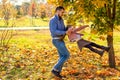 Dad and daughter in the autumn park play laughing Royalty Free Stock Photo