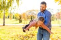 Dad and daughter in the autumn park play laughing Royalty Free Stock Photo