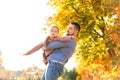 Dad and daughter in the autumn park play laughing Royalty Free Stock Photo