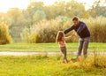 Dad and daughter in the autumn park play laughing Royalty Free Stock Photo