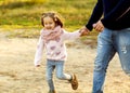 Dad and daughter in the autumn park play laughing Royalty Free Stock Photo