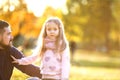 Dad and daughter in the autumn park play laughing Royalty Free Stock Photo