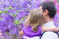 Dad and daughter in the background of purple wood