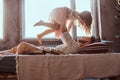 Dad and daughter in bed. Father playing with adorable daughter in bedroom.