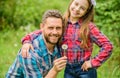 Dad and daughter blowing dandelion seeds. Keep allergies from ruining your life. Seasonal allergies concept. Outgrow