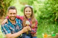 Dad and daughter blowing dandelion seeds. Keep allergies from ruining your life. Seasonal allergies concept. Outgrow