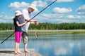 Dad and daughter caught a fish in a bait in the lake Royalty Free Stock Photo