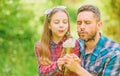 Dad and daughter collecting dandelion flowers. Keep allergies from ruining your life. Seasonal allergies concept Royalty Free Stock Photo