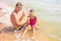 Dad and daughter are considering found underwater shell Royalty Free Stock Photo