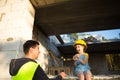 Dad and daughter are at construction site of their future home. The choice of the future profession of a builder is inherited by Royalty Free Stock Photo
