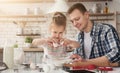 Dad and daughter cooking surprise cake for mom Royalty Free Stock Photo