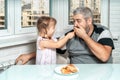 Dad and daughter eat pancakes and spend time together Royalty Free Stock Photo