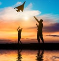 Dad and daughter flying a kite on the beach