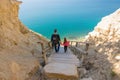 Dad and daughter go down the steep mountain stairs to the sea Royalty Free Stock Photo