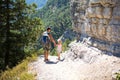 Dad and daughter go hiking on a mountain trail. Active family holidays, healthy lifestyle, trekking with a backpack, adventures of Royalty Free Stock Photo