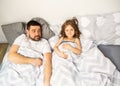 Dad and daughter have fun at home on the bed. Father`s Day. Royalty Free Stock Photo