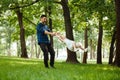 Dad and daughter have fun in park, girl flies with her father in his arms. Happy childhood