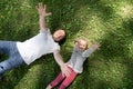 Dad and daughter lie on the grass Royalty Free Stock Photo