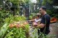 dad and daughter look at butterflies. father holds a little toddler girl in his arms in the butterfly park. tropical zoo