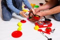 Dad and daughter play with sliced plastic vegetables and fruits with Velcro, cooks food on a toy stove in a bowl. Children`s