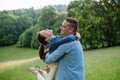 Dad with daughter, playing at meadow, hugging, having fun. Concept of fathers's Day and fatherly love. Royalty Free Stock Photo