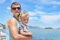 Dad and daughter playing on the promenade by the sea. young man, little girl Royalty Free Stock Photo