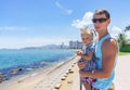 Dad and daughter playing on the promenade by the sea. young man, little girl Royalty Free Stock Photo