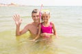 Dad and daughter seven years at sea, Pope waved his hand, my daughter wearing a mask and tube Royalty Free Stock Photo