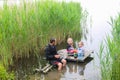 Dad with daughter and son fishing together on wooden pier at river Royalty Free Stock Photo