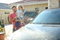 Dad and daughter washing car at backyard Royalty Free Stock Photo