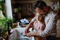 Dad and daughter washing dishes in sink together. Girls dad. Unconditional paternal love, Father& x27;s Day concept. Royalty Free Stock Photo