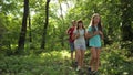 Dad and daughters, children travel in park in summer. Family on vacation travels in forest. friends-tourists go camping