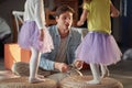 Dad is drumming with spoons on the furniture and his little daughters dancing. Family, home, playing, togetherness Royalty Free Stock Photo