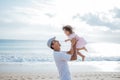 Dad enjoy playing with his daughter on the beach having fun together Royalty Free Stock Photo