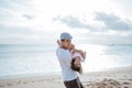 Dad enjoy playing with his daughter on the beach having fun together Royalty Free Stock Photo