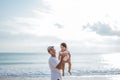 Dad enjoy playing with his daughter on the beach having fun together Royalty Free Stock Photo