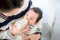 Dad feeding her baby daughter infant from bottle Adorable baby with a milk bottle. Royalty Free Stock Photo