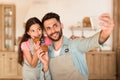 Dad and girl with homemade cookies take a selfie Royalty Free Stock Photo