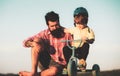 Dad help his child ride a bicycle. Lovely father teaching son riding bike. Royalty Free Stock Photo