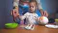 Dad helping daughter colorizing hand made craft pumpking