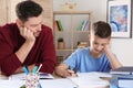 Dad helping his son with difficult homework assignment Royalty Free Stock Photo
