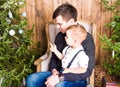 Dad helping son to decorate christmas tree Royalty Free Stock Photo