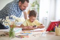 Dad helps his son to do homework. home schooling, home lessons. outside school classes with parents. father examines with his son