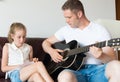 Dad and his daughter compose a song. Royalty Free Stock Photo