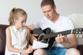 Dad and his daughter compose a song. Royalty Free Stock Photo