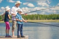 Dad with his daughter and son on a fishing Royalty Free Stock Photo