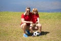 Dad with his little cute son are having fun and playing football on green grassy summer lawn. Football soccer sport Royalty Free Stock Photo