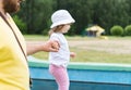 Dad and his little daughter on a walk in the park. A father holds the hand of his little girl in the open air. The concept of fami Royalty Free Stock Photo